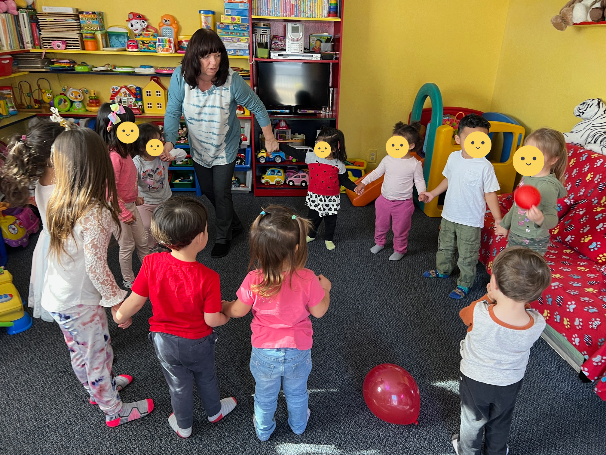 Children playing in a circle with Lucy leading them around.